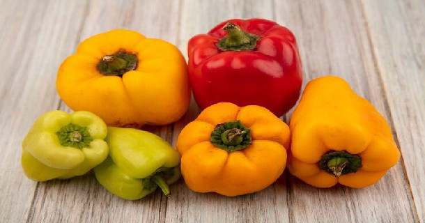 top-view-healthy-colorful-bell-peppers-isolated-grey-wooden-wall_141793-76167